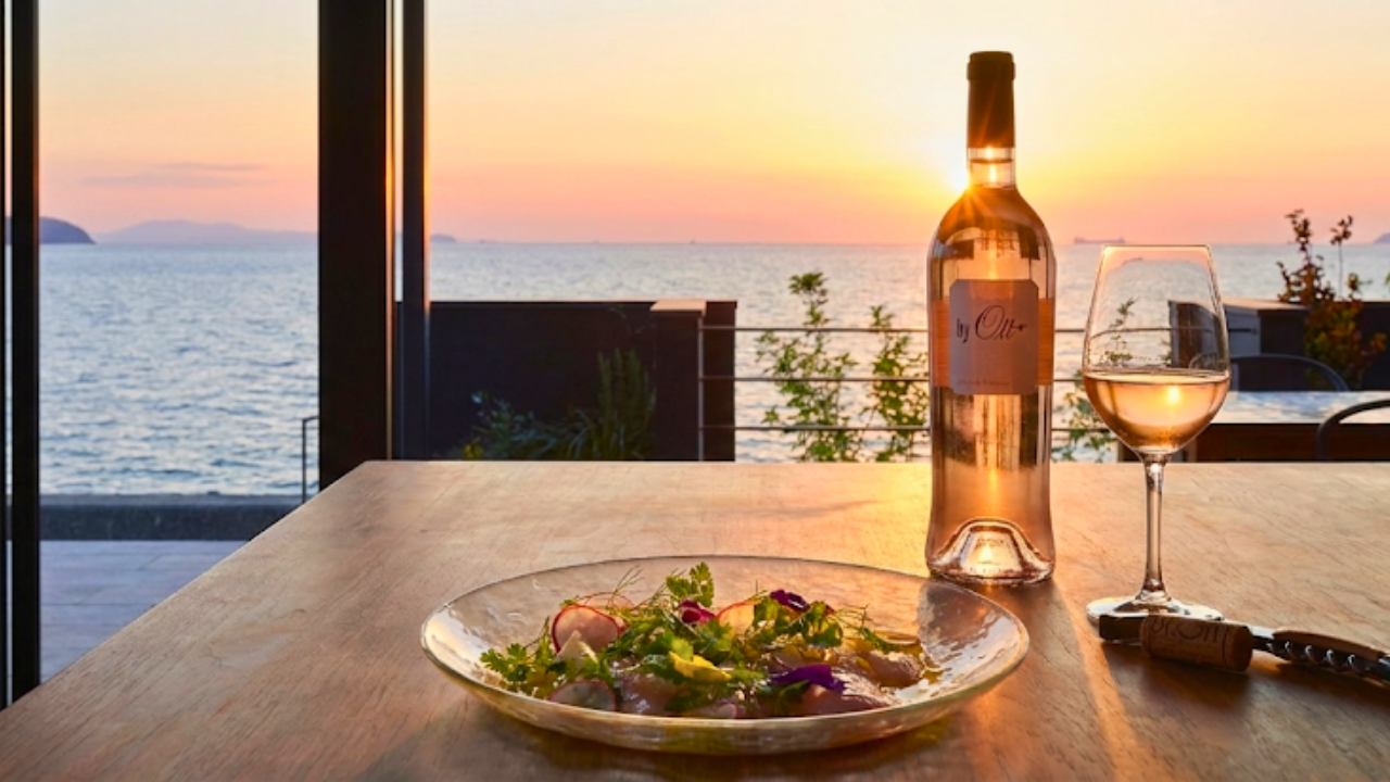 "Red Sea Bream Carpaccio with Yuzu and Edible Flowers, paired with a bottle of By. Ott Rose wine"